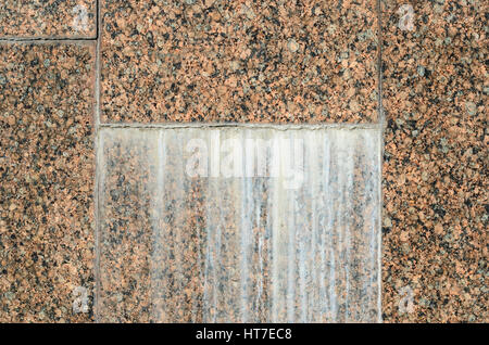 Dirty stains on Red granite wall. Granite Texture, Red Base with Black and Gray Spots Stock Photo