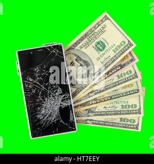 Smartphone with broken display lying on money banknotes Isolated on green chroma key background. Need new smartphone concept Stock Photo
