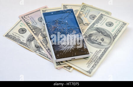 Smartphone with broken display lying on money banknotes on white background. Need new smartphone concept Stock Photo