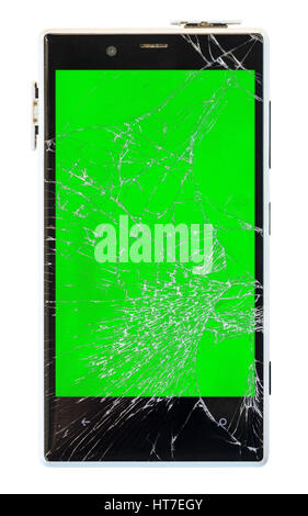 Smartphone with broken screen isolated on white background with cliping path. Green chroma key display of damaged cellphone Stock Photo