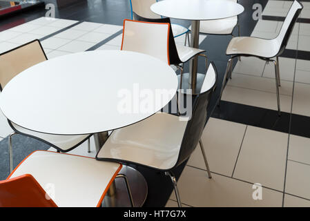 White plastic tables and chairs in a cafe Stock Photo