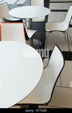 White plastic tables and chairs in a cafe Stock Photo