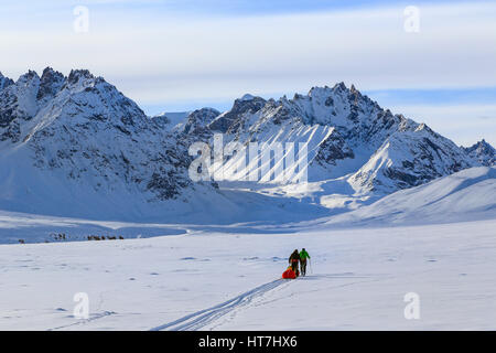 Mountaineering Team Pulling Pulk Sleds On The Way To The Stauning Alps In Greenland Stock Photo
