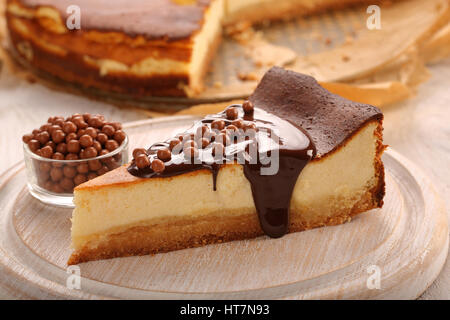 Christmas cheesecake slice with melted chocolate and chocolate balls Stock Photo