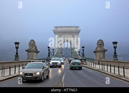 The Széchenyi chain bridge half hidden in the fog. Budapest, Hungary. Photo taken from the side of Pest. Stock Photo