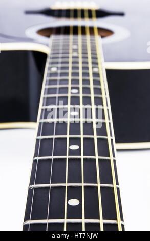 Close up of acoustic guitar strings. Instrument lying on a white background Stock Photo