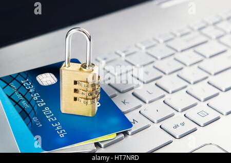 Laptop with padlock and credit cards on keyboard. Computer systems security concept Stock Photo