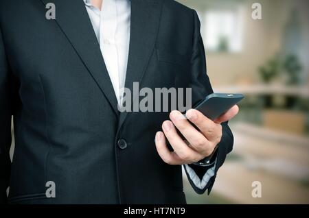 Business man in suit using smart phone in office Stock Photo
