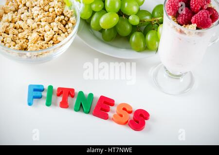 Fitness word made up of letters with magnets. Composition of healthy food Stock Photo