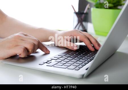 Man working with modern laptop in office. Hands typing on keyboard Stock Photo