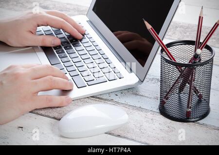 Man working with modern laptop in office. Hands typing on keyboard Stock Photo