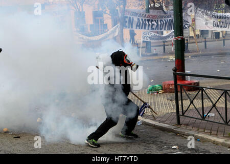 Athens, Greece. 8th Mar, 2017. Riot police clashes with protesting farmers outside the greek Agriculture Ministry. Police fired tear gas to prevent farmers from forcing their way into the ministry building, while protesters responded by throwing stones. No injuries or arrests were reported. Protesters are angry at increases in their tax and social security contributions, part of the income and spending cuts Greece's left-led government has implemented to meet bailout creditor-demanded budget targets Credit: Aristidis Vafeiadakis/ZUMA Wire/Alamy Live News Stock Photo