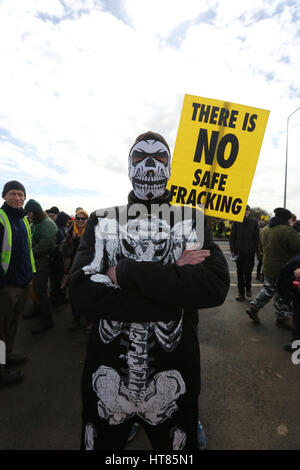 Fylde, Lancashire, UK. 8th Mar, 2017. A man wearing a skeleton outfit stood in front of a sign which reads 'There is no safe fracking', Fylde, Lancashire, 8th March, 2017 Credit: Barbara Cook/Alamy Live News Stock Photo