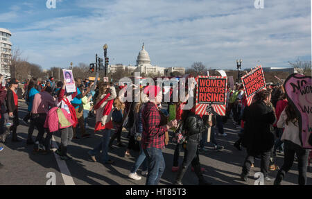 Washington, DC, USA. 8th March, 2017. Demonstrators march from the U.S. Labor Department headquarters to bnearby park (US Capitol in background). Part of nationwide protests coinciding with International Women's Day and the “Day Without a Woman.”  During the late afternoon rally, speakers demanded an end to workplace violence and harassment, pay equity, one fair living wage, paid leave, and labor rights at the workplace. Credit: Bob Korn/Alamy Live News Stock Photo