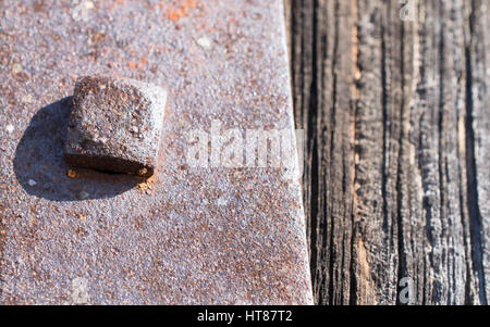 Old Rusty Bolt on Barn Door Hinge Stock Photo