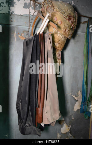 Clothes in Closet of Abandoned Building Stock Photo