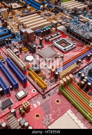 Detail of an electronic printed circuit board with many electrical components Stock Photo