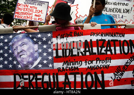 Manila, Philippines. 08th Mar, 2017. A mock US flag with Trump's face was burned by the protesters near the US embassy. Women rights group Gabriela, lead a march to the U.S. embassy in Manila, noon Wednesday in observation of International Women's Day. Credit: J Gerard Seguia/Pacific Press/Alamy Live News Stock Photo