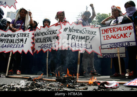 Manila, Philippines. 08th Mar, 2017. A mock US flag with Trump's face was burned by the protesters near the US embassy. Women rights group Gabriela, lead a march to the U.S. embassy in Manila, noon Wednesday in observation of International Women's Day. Credit: J Gerard Seguia/Pacific Press/Alamy Live News Stock Photo