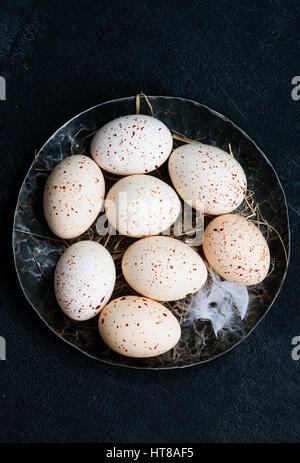raw chicken eggs on plate and on a table Stock Photo