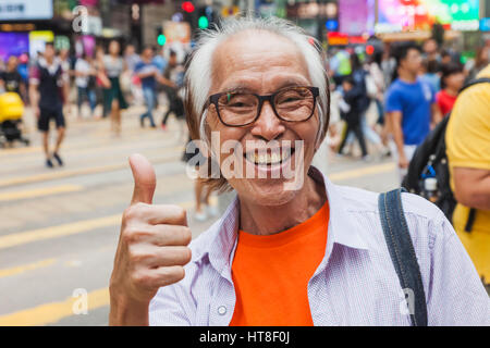 China, Hong Kong, Causeway Bay, Smiling Man Giving Thumbs Up Sign Stock Photo