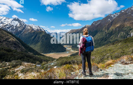 Hiker overlooks the Routeburn Flats, Routeburn Track, behind Humboldt Mountains, Westland District, West Coast, Southland Stock Photo