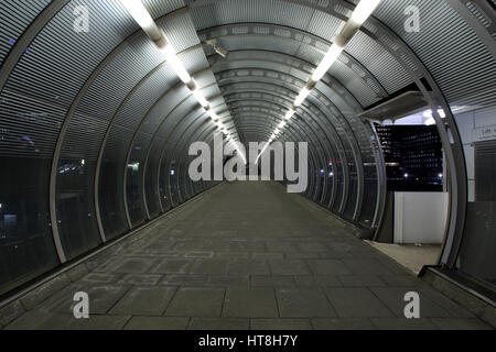 Pedestrian walkway and tunnel at Poplar Docklands light Railway station Stock Photo