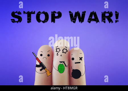 Three fingers decorated as three person holding weapons. Stock Photo