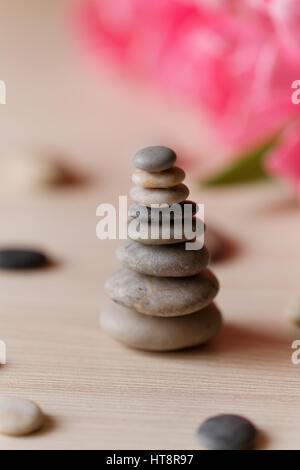 Zen stones on the beige wooden background Stock Photo