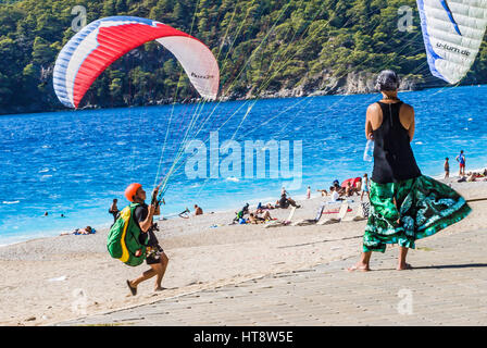 paragliding training on the beach,woman watches Stock Photo
