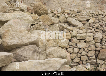 pile of bricks made from white limestone for renovation of medieval castle Stock Photo