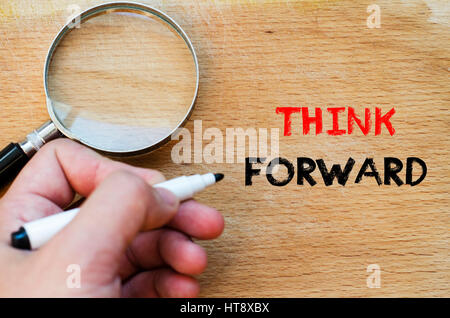 Human hand over wooden background and think forward text concept Stock Photo