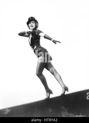 'Eleanor Powell, off on a strut, with knees bent in cake-walk fashion and arms swinging to the rear. Miss Powell is now rehearsing on her new routines for the forthcoming Metro-Goldwyn-Mayer musical extravaganza, 'Born to Dance,' which is to be directed by Roy Del Ruth. A galaxy of celebrities including Frank Morgan, James Stewart, Virginia Bruce, Una Merkel, Frances Langford, Buddy Ebsen and Sid Silvers are to be featured in the cast.' Stock Photo