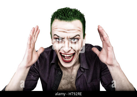 guy with crazy joker face, green hair and idiotic smike. carnaval costume. Stock Photo