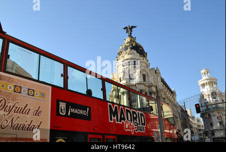 Tourist bus near Metropolis Building in Gran Via, Madrid, Spain Stock Photo