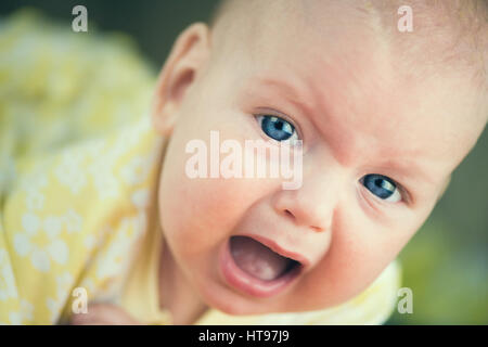 Portrait of crying baby girl. Stock Photo