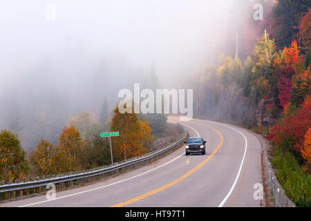 A truck driving through fog in Algonquin Provincial Park, Ontario, Canada. Stock Photo