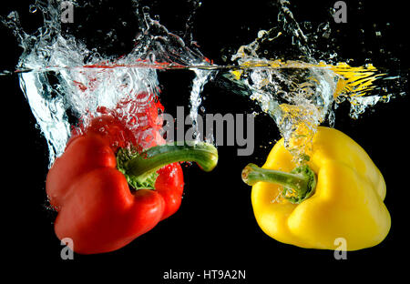 Splash water from water droping bell pepper in black background with studio lighting. Stock Photo