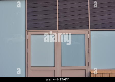 Panes of various colors and gate on commercial building. Stock Photo