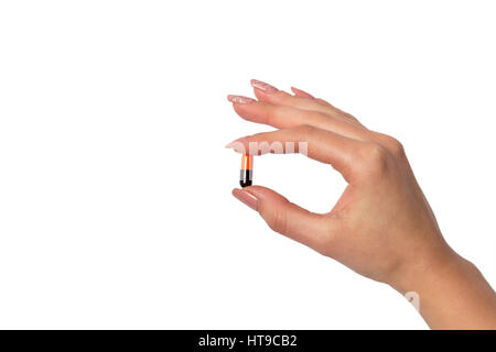 Hand holding a capsule or pill isolated on white Stock Photo