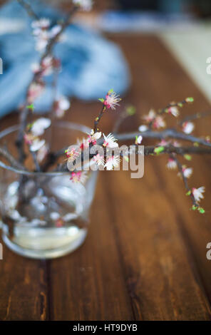 Sprig blossoming branch on wooden table and empty space for text. Copy space. Spring time