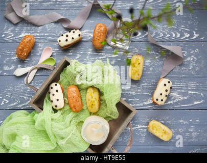 Eclairs with chocolate and whipped cream on dark background. Traditional French dessert. Top view. Stock Photo