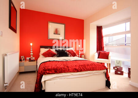 Modern Bedroom With Red Wall And Modern Decor Stock Photo