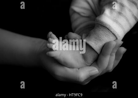 mother's protection is in her small gestures Stock Photo
