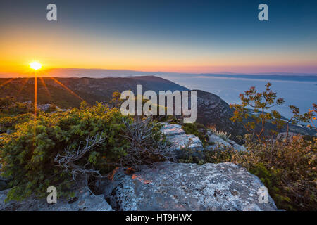 Sunrise from Vidova Gora rocky mountain peak on the Island of Brac. Adriatic sea. Croatia. Europe. Stock Photo