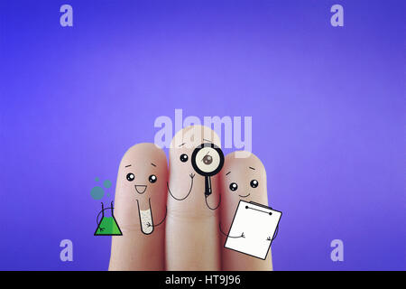 Three fingers decorated as three happy friends doing research. Suitable to be used for anything about science and research. Stock Photo