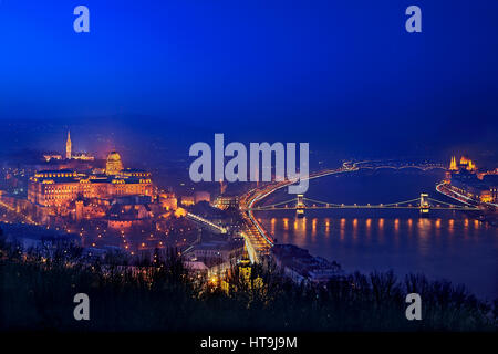 Night falling in Budapest, Hungary. View from Gellert Hill and Citadella castle, on the side of Buda. Stock Photo