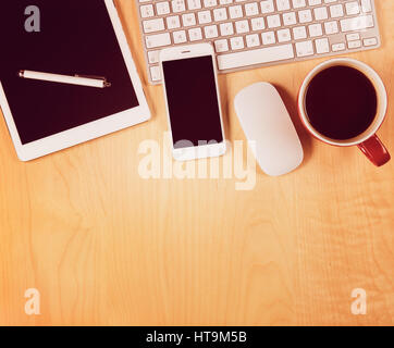 Office table with digital tablet, smartphone and cup of coffee. View from above with copy space Stock Photo