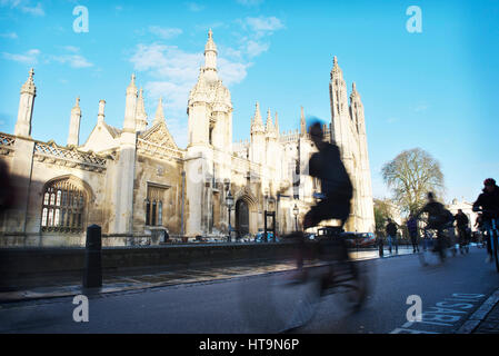 Rush hour in Cambridge in front of Kings College, as bicycle students and commuters cycle along the road, blurred from the movement