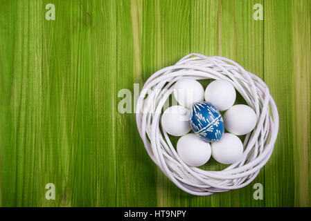 Flat lay view of painted and white easter eggs. Stock Photo